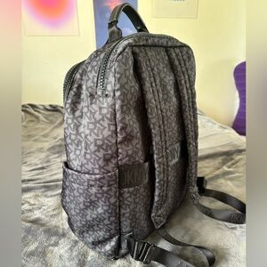 DKNY Black patterned backpack. Three compartments.
